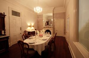 a dining room with a table and chairs and a chandelier at Laurelville in York
