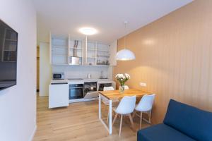 a kitchen and dining room with a table and chairs at 23441 Cozy apartment nearby with Central Railway Station in Kyiv
