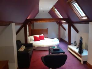 a bedroom with a bed with red pillows on it at High Tor Hotel in Matlock