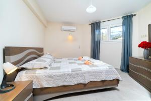 a bedroom with a large bed and a window at SYKA Thassos - Apartment down floor SKALA RACHONIOU in Skala Rachoniou