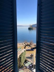 a door open to a view of a body of water at Villa Toscanini in Stresa