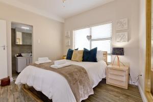 a bedroom with a large bed with blue pillows at Beachfront Apartment @ Morleenpark unit 11 in Swakopmund