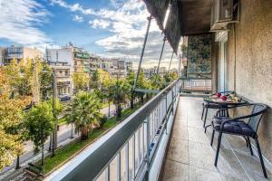 a balcony with a table and a view of a city at Gazi apartment with Acropolis views in Athens