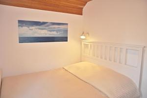 Un pat sau paturi într-o cameră la PW Strandmuschel