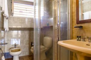 a bathroom with a toilet and a sink and a shower at La Plage - Home and Sea in Nizza di Sicilia