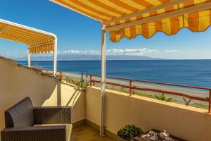 a balcony with a view of the ocean at La Plage - Home and Sea in Nizza di Sicilia