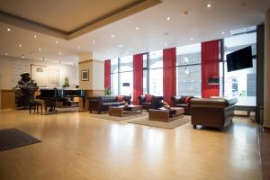 a living room with a grand piano in a building at martas Hotel Lutherstadt Wittenberg in Lutherstadt Wittenberg