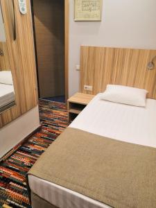 モスクワにあるWesendorf Tagankaのベッドと鏡が備わるホテルルーム