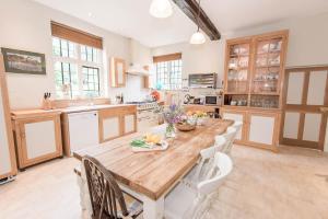 a large kitchen with a wooden table and chairs at King Johns House in Salisbury