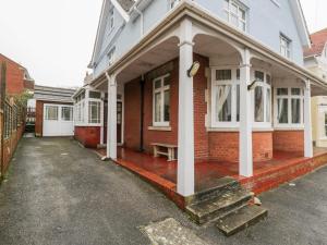 a house with a porch with a bench on it at 20 Ulwell Road in Swanage