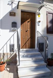 a front door of a house with stairs at Brio Bed & Breakfast in Agrigento