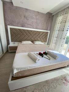 a bedroom with a large bed with flowers on it at Villa Premier in Ulcinj