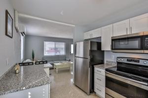 A kitchen or kitchenette at Ocean Eleven Suites