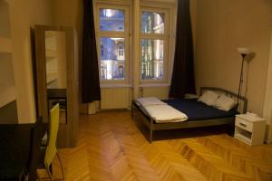 a small bedroom with a bed and a window at Vitae Hostel in Budapest