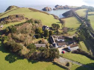 an aerial view of a house on a hill next to a lake at Swallow Cottage in Ilfracombe