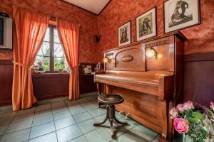 
a piano sitting in a room next to a window at Hotel Golfer in Kremnica
