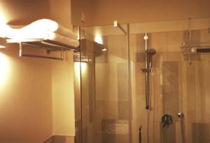 a shower with a glass door in a bathroom at Casa Dora in Cesena