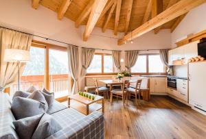 a living room with a couch and a table at Residence Sovara in Santa Cristina in Val Gardena