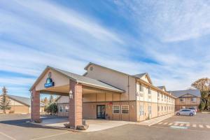 a hotel front of a building with a parking lot at Days Inn by Wyndham Ellensburg in Ellensburg