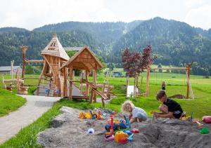 a couple of children playing in the sand in a sandbox at Alpen Hotel Post in Au im Bregenzerwald