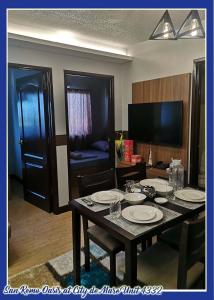 a dining room with a table with plates on it at San Remo Oasis at City de Mare U4332 in Cebu City