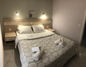 a bedroom with a bed with towels on it at Aloni Studios and Apartments in Lassi