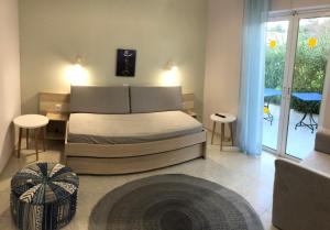 a bedroom with a bed with two tables and a window at Aloni Studios and Apartments in Lassi