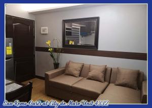 ein Wohnzimmer mit einem Sofa und einem Spiegel in der Unterkunft San Remo Oasis at City de Mare U4332 in Cebu City