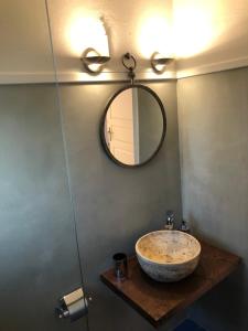 a bathroom with a sink and a mirror at Aloni Studios and Apartments in Lassi