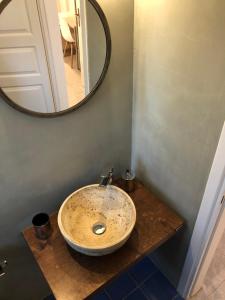 a bathroom with a sink and a mirror on a counter at Aloni Studios and Apartments in Lassi