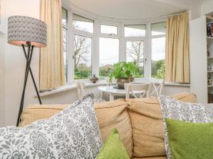 a living room with a couch and a table at Hilltop in Totnes