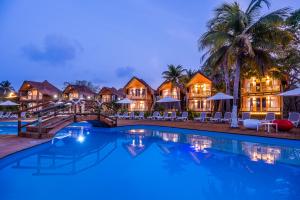 a villa with a swimming pool at night at Hotel Isla del Encanto in Barú