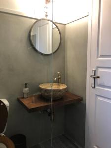 a bathroom with a sink and a mirror at Aloni Studios and Apartments in Lassi