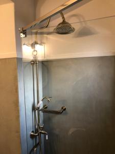 a shower stall in a bathroom with a light at Aloni Studios and Apartments in Lassi +37 photos
