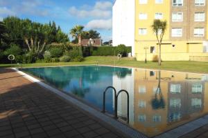 a swimming pool with a reflection in the water at APARTAMENTO EN A ESTRADA/GALICIA in A Estrada