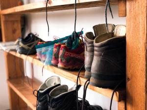 a bunch of boots on shelves in a closet at O Refuxio de la Jerezana in Redondela