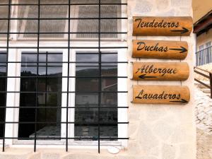 a building with signs on the side of it at O Refuxio de la Jerezana in Redondela