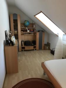 a attic room with a bed and a skylight at Ahorn 11 in Laumersheim