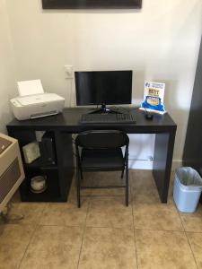 a black desk with a computer and a printer at Travelodge by Wyndham Elko NV in Elko