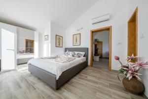 a bedroom with a bed and a bathroom at Apartment Starčević in Kampor