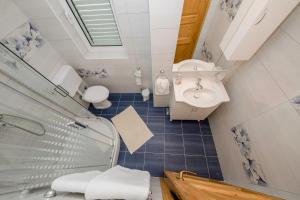 a bathroom with a shower and a sink and a toilet at Apartment Starčević in Kampor +41 photos