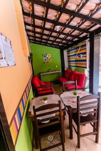 a room with two tables and chairs and a couch at Pousada Dunas Braga in Cabo Frio