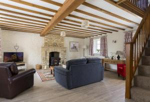 a living room with two couches and a fireplace at Alysas Cottage in Chipping Norton