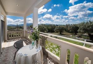 a balcony with a table and chairs and a view at VILLA FAIRIES in Lygia
