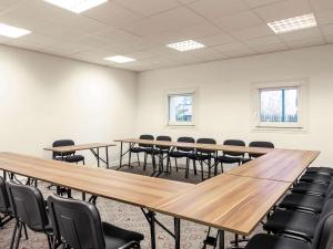 a large room with tables and chairs in it at ibis Epinay sur Seine - Gennevilliers in Épinay-sur-Seine