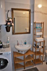 a bathroom with a sink and a mirror at Istrabella Apartment in Koper +59 photos