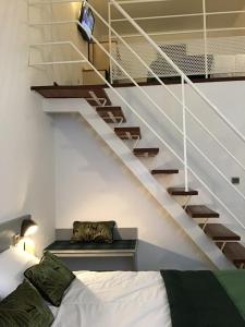 a bedroom with a bed and a staircase at Hôtel Christ Roi in Lourdes