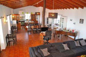a living room with a couch and a dining room at B&B Quinta O Ninho in Monchique