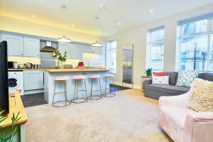 a kitchen and living room with a couch and a table at Stunning Gems of Harrogate in Harrogate