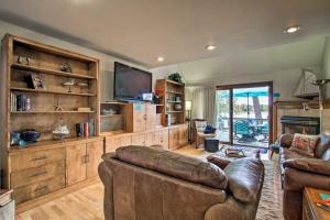 a living room with a couch and a flat screen tv at Lakefront Fort Collins Townhome, Only 3 Mi to CSU! in Fort Collins